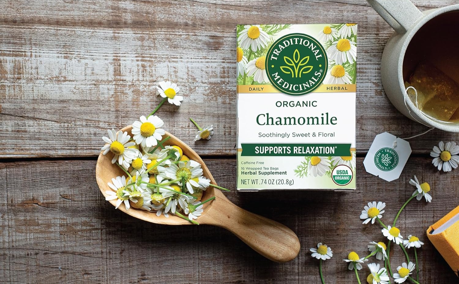 Box of Traditional Medicinals Organic Chamomile tea with chamomile flowers and a cup of tea.