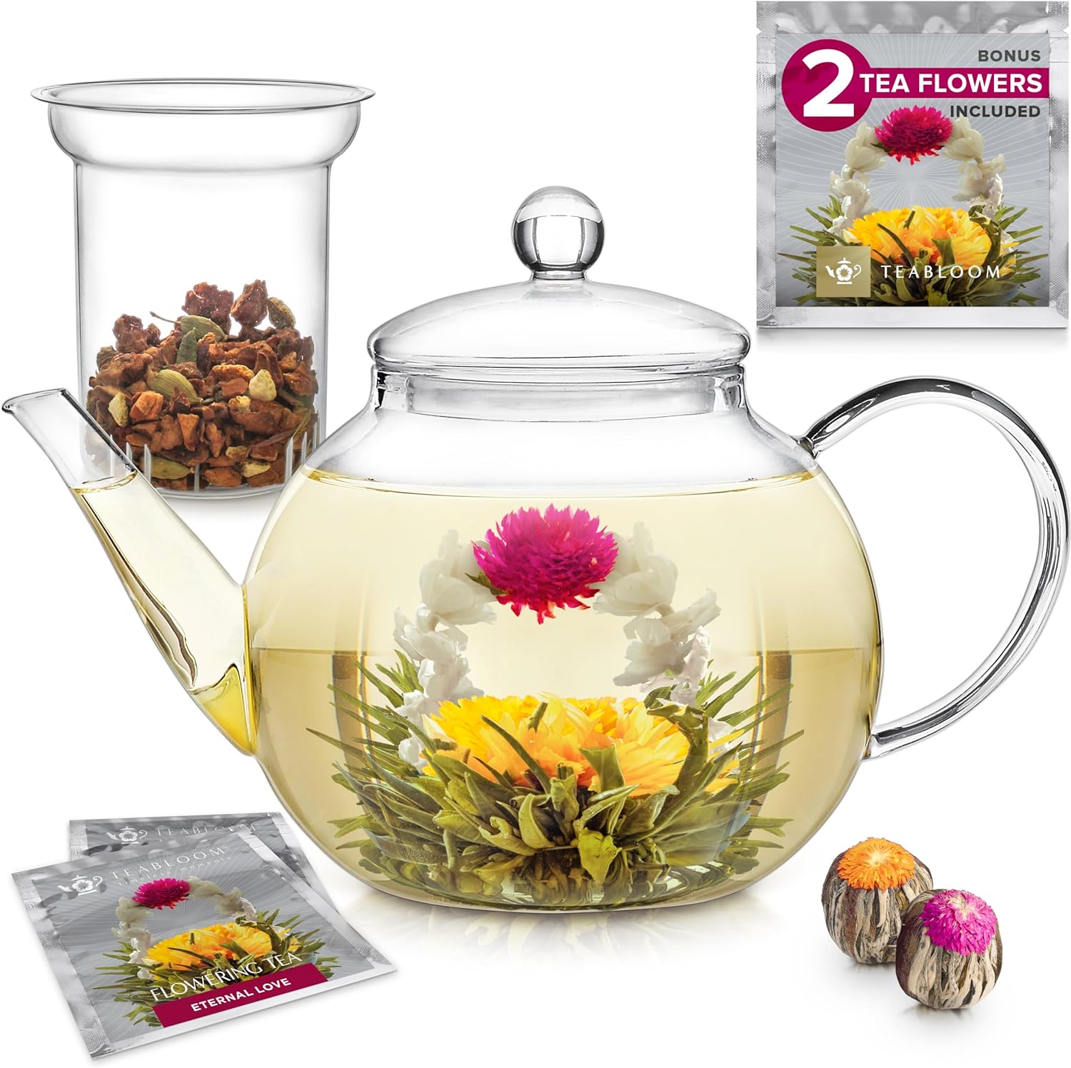 Glass teapot with blooming tea flower, loose tea, and packaging for two bonus tea flowers.