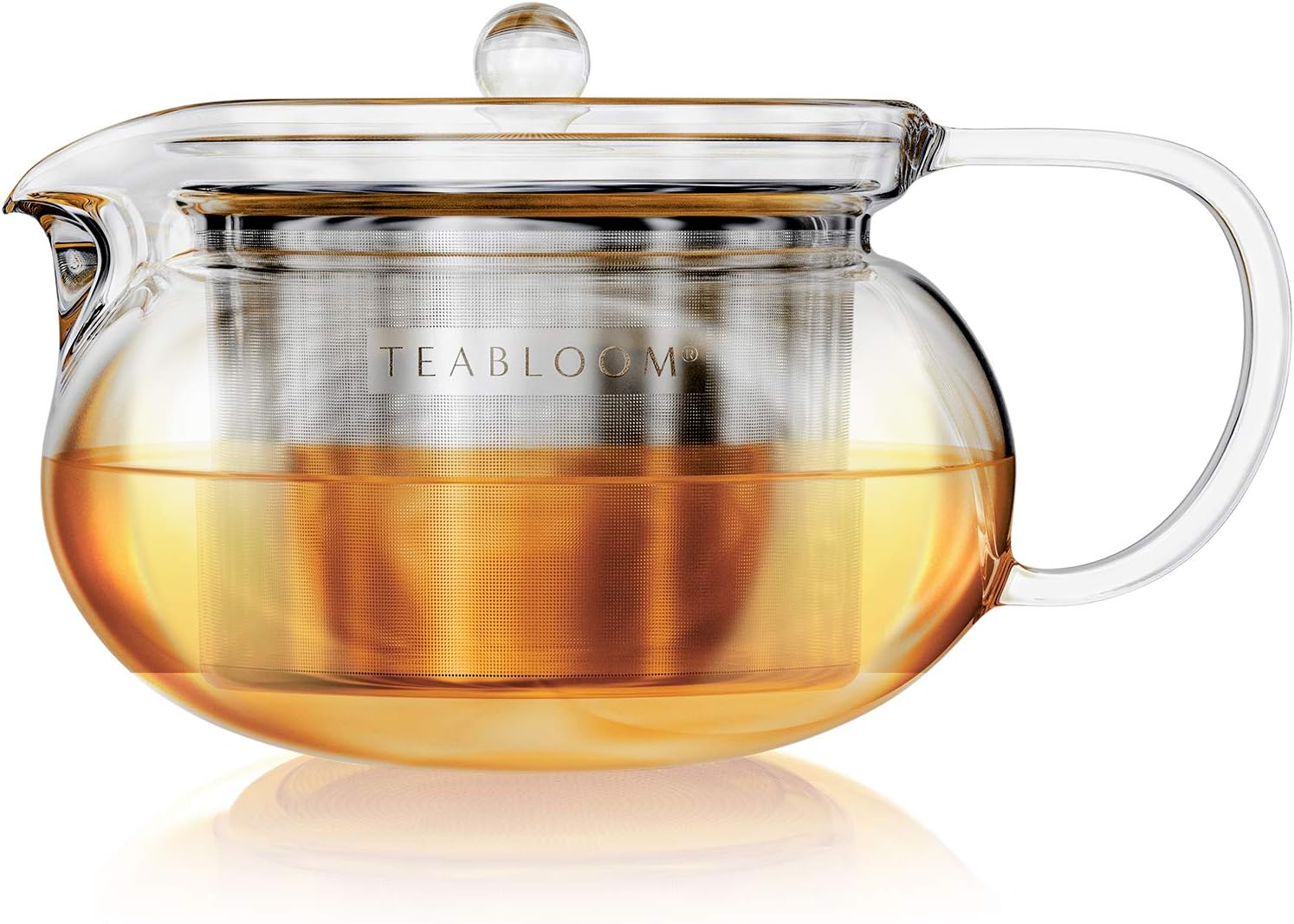 Glass teapot with metal infuser, filled with amber tea, labeled "TEABLOOM".